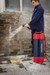 Man washing brick wall with portable pressure washer system.