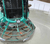 Ride-on power trowel finishing a freshly laid concrete floor