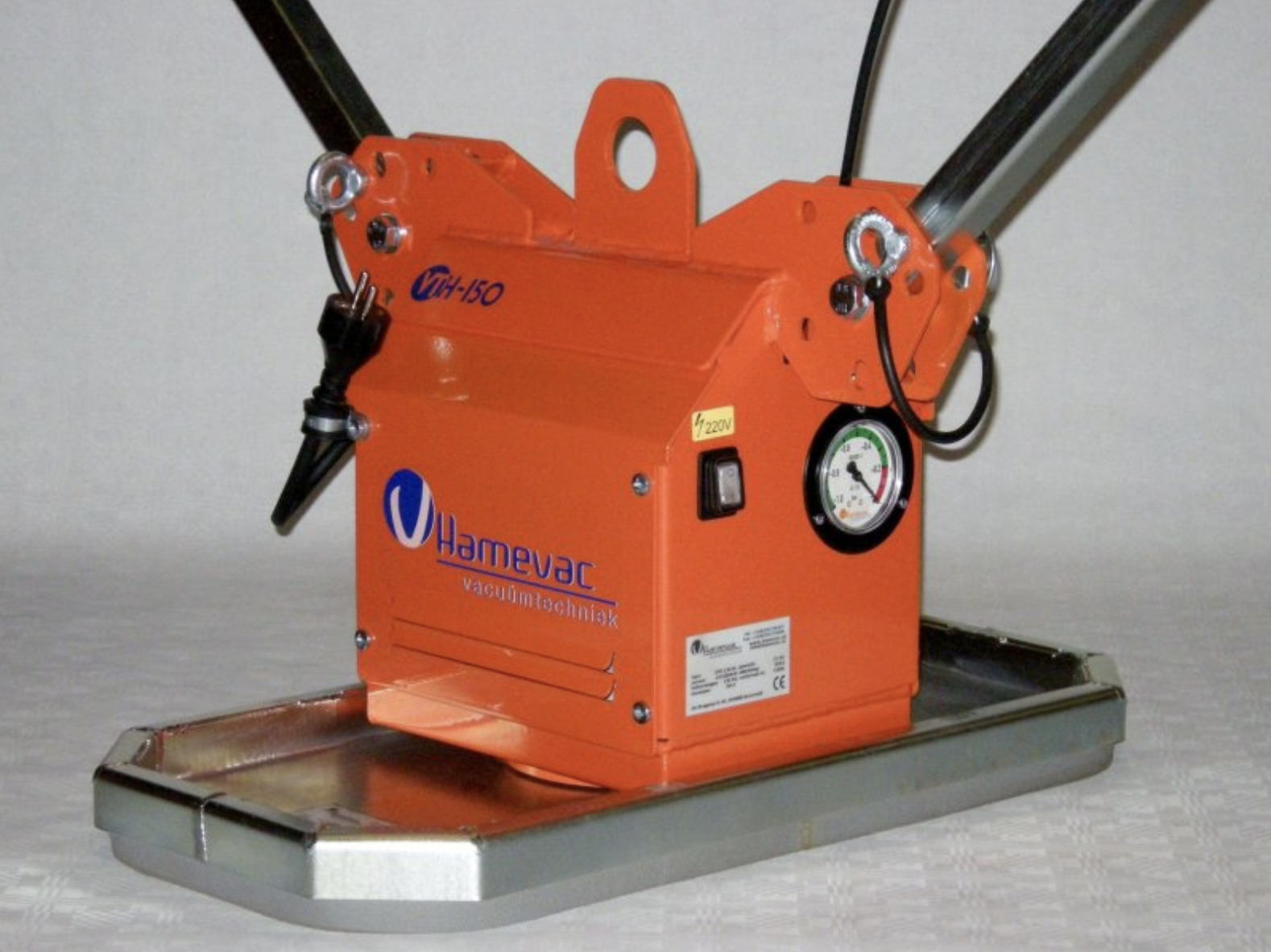 Industrial orange and silver hamnevac vacuum lifter, featuring two black handles and operational gauges.